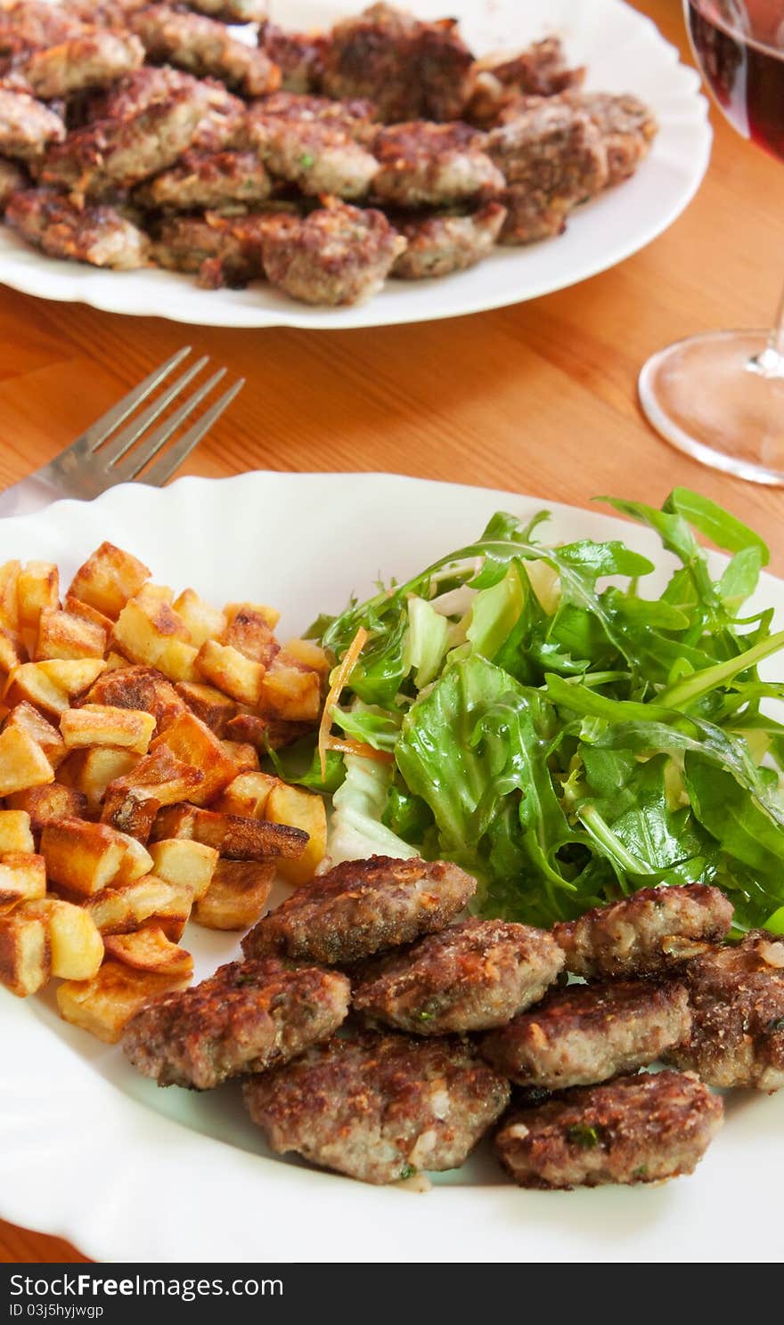 Meatballs with beef and spices, fries potatoes and