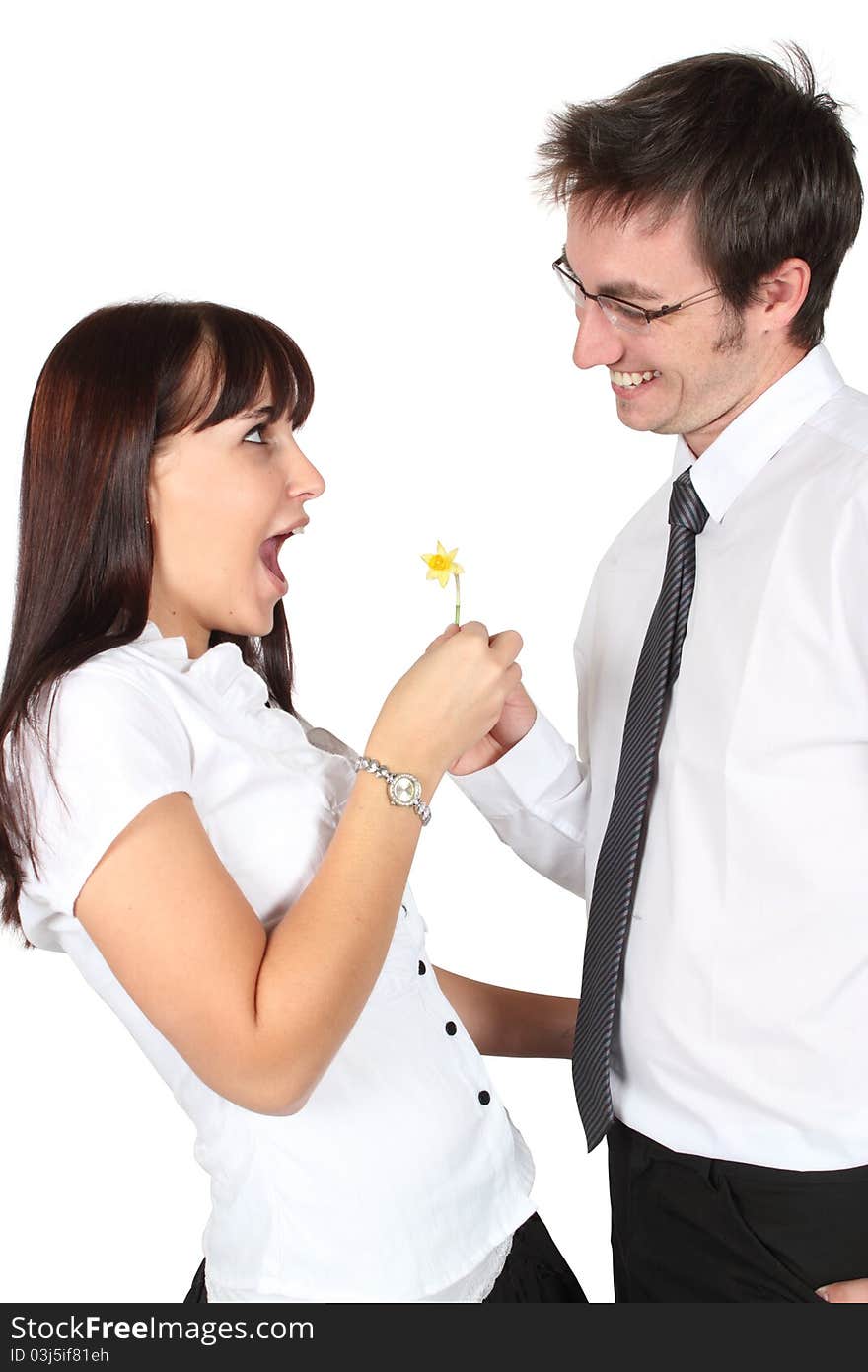 Surprised lady receiving a small daffodil from a man