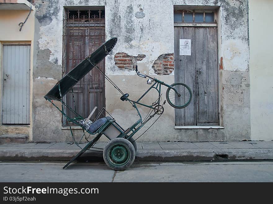 Three wheeler bike in the streets of a Cuban village. Three wheeler bike in the streets of a Cuban village