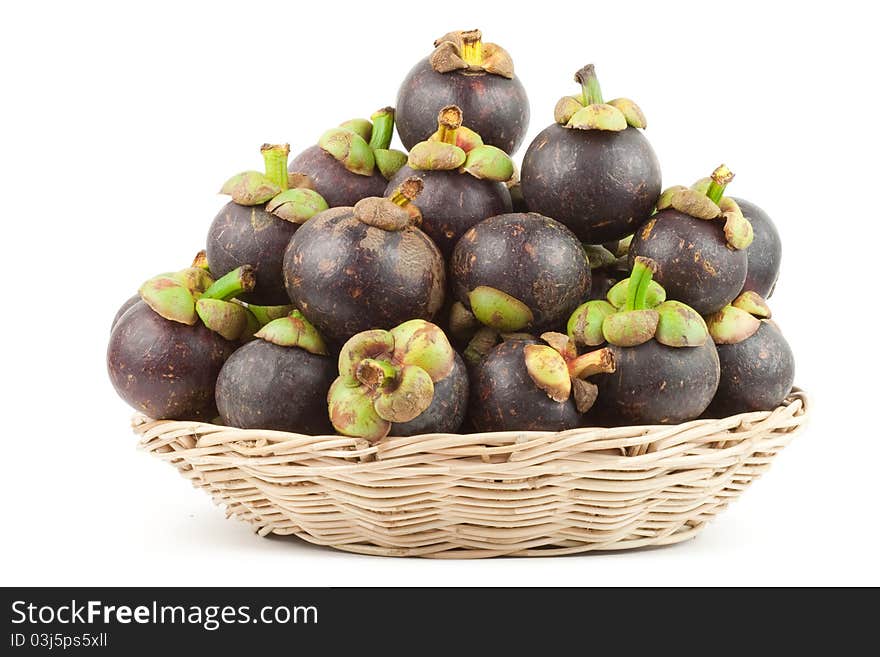 Isolated Mangosteens in a basket. Isolated Mangosteens in a basket