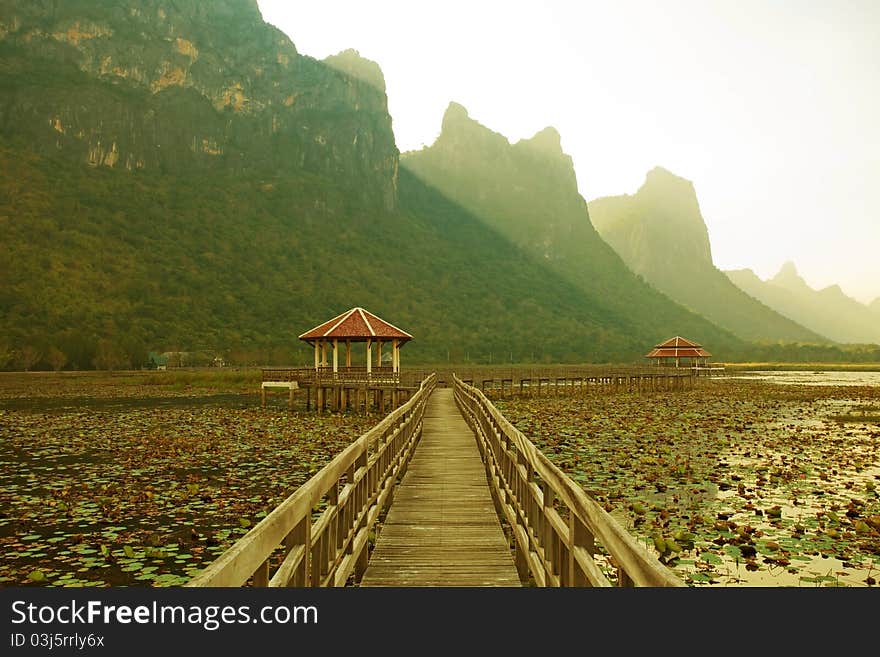 Footbridge in lake into the mountain, thailand