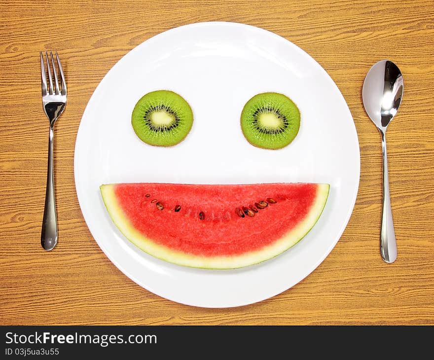 Smile watermelon and kiwi served on white plate. Smile watermelon and kiwi served on white plate