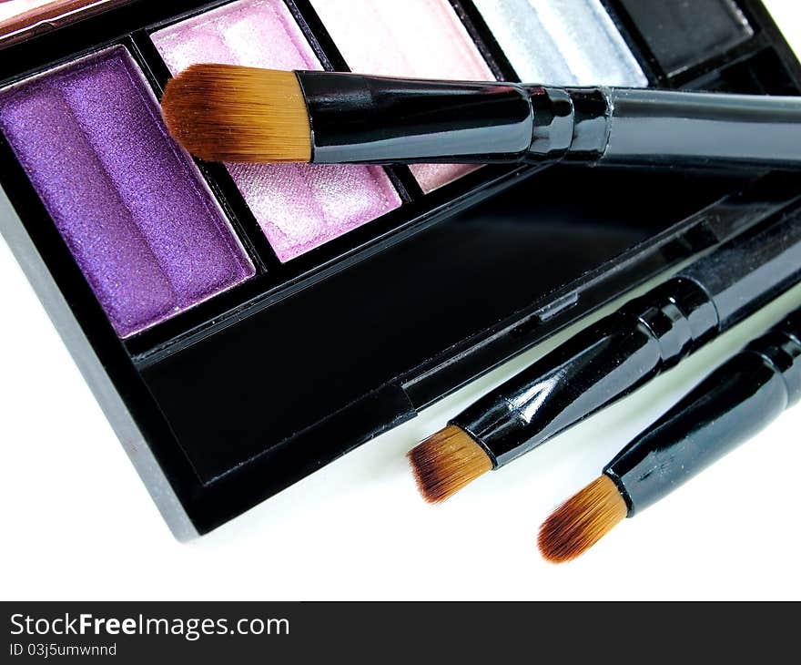 Make-up brush with colorful crushed eyeshadows. Make-up brush with colorful crushed eyeshadows