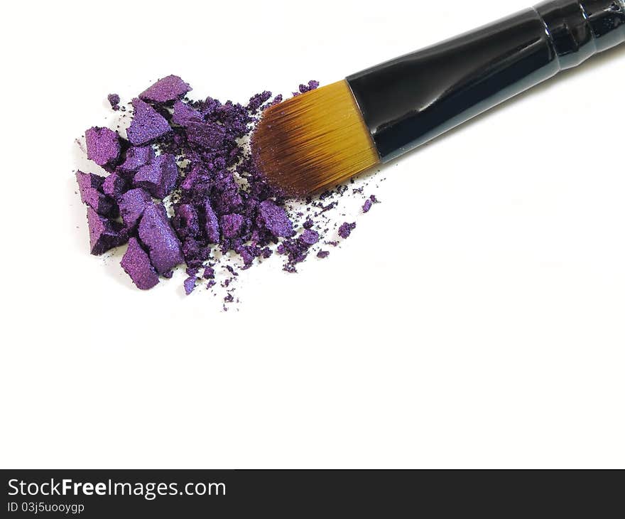 Make-up brush with colorful crushed eyeshadows. Make-up brush with colorful crushed eyeshadows