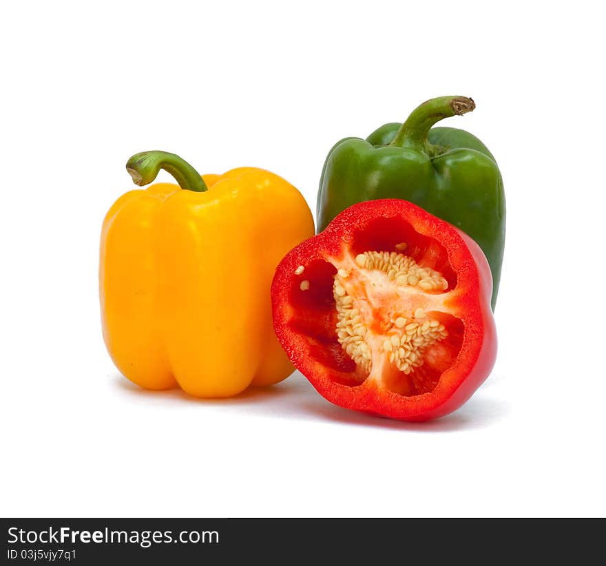 Three sweet peppers in yellow, red and green color