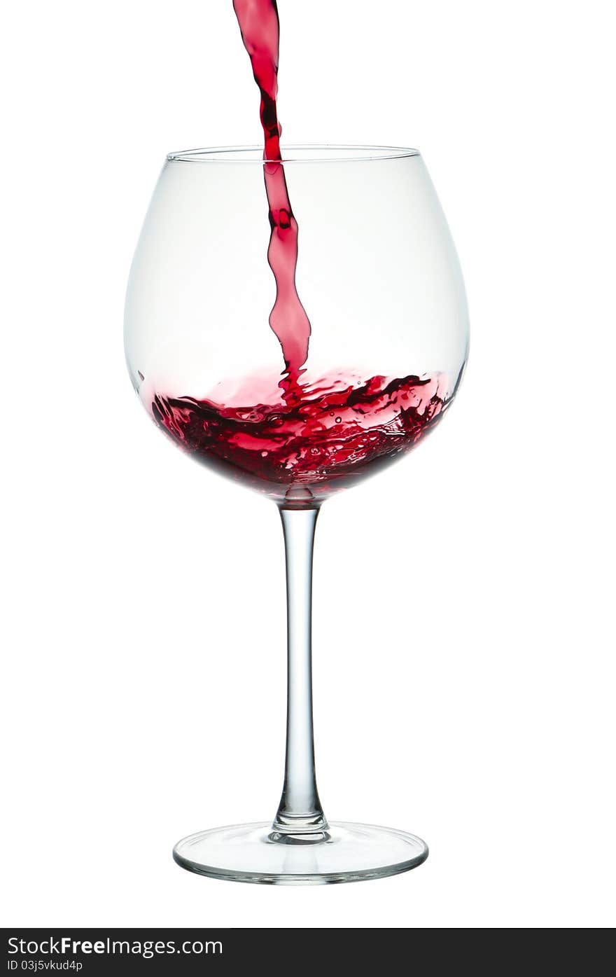 Stream of red wine falling in glass