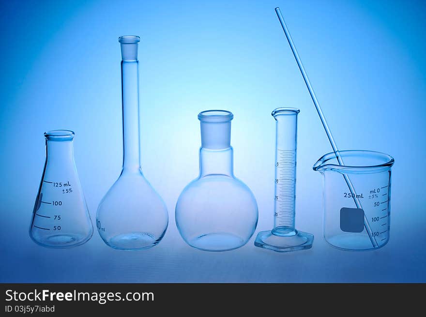 Laboratory glass on a blue background