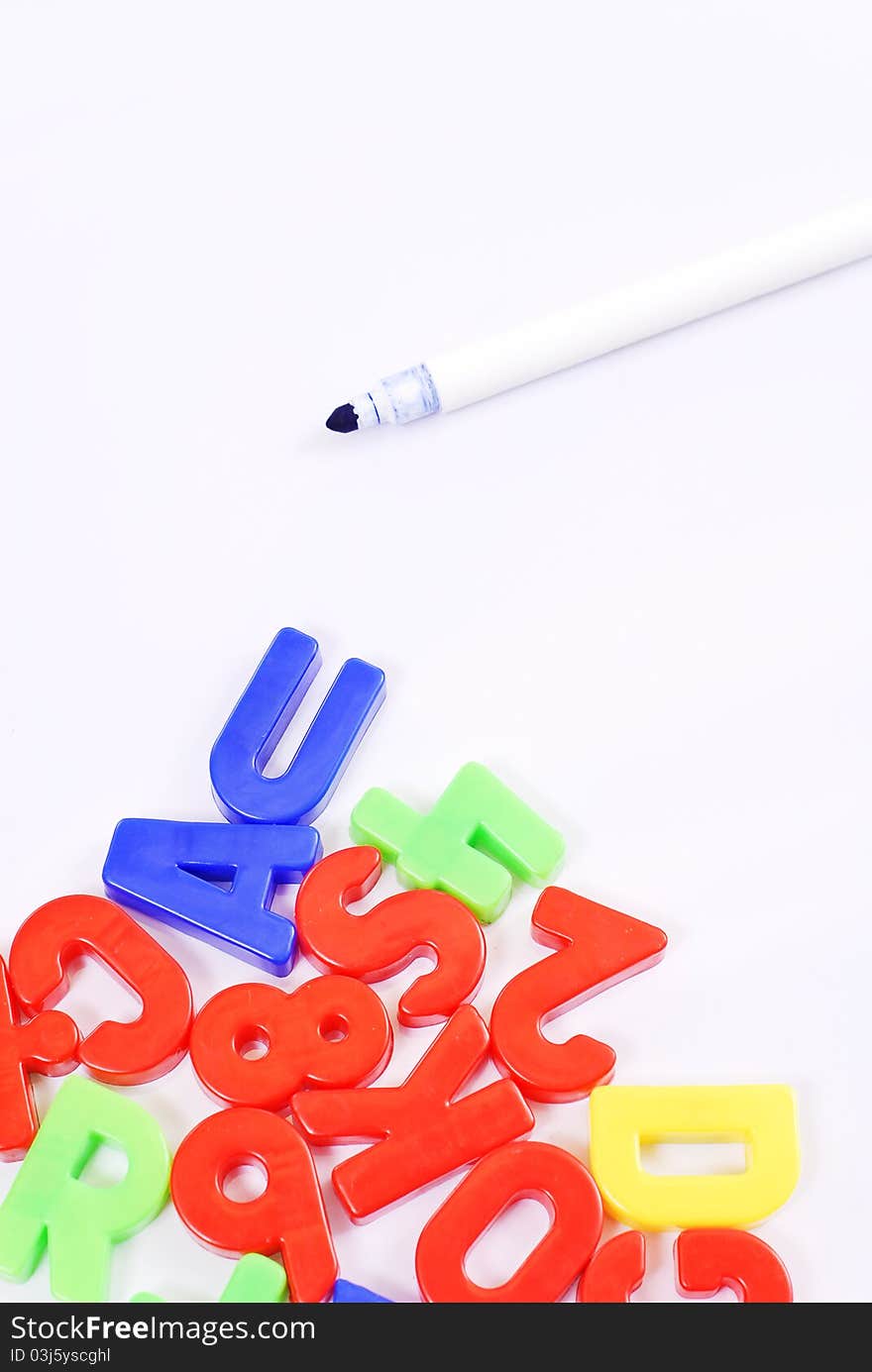 Colorful Letter Magnets And Pen On Whiteboard. Colorful Letter Magnets And Pen On Whiteboard