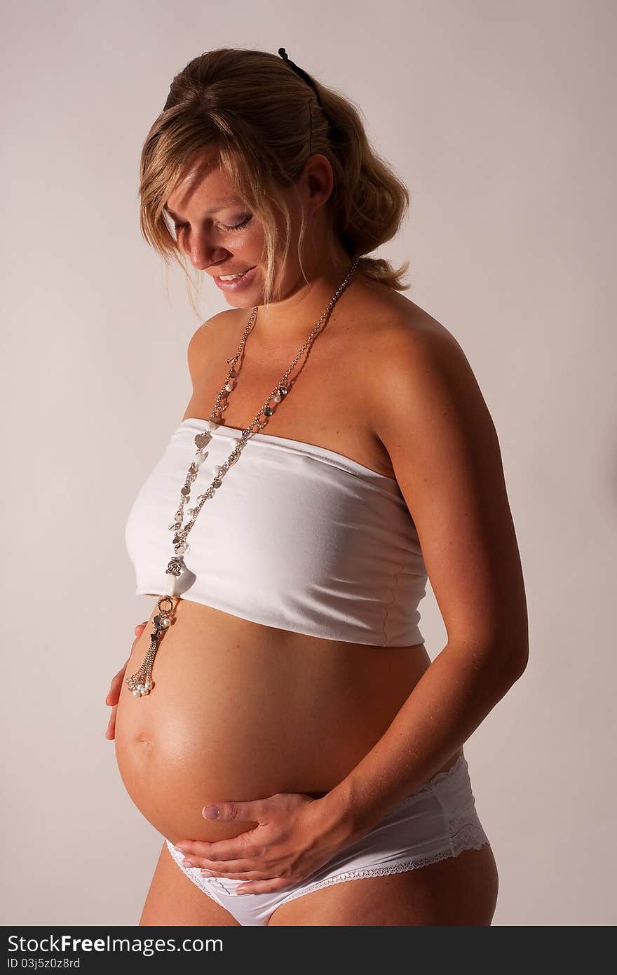 A pregnant woman posing with big belly. A pregnant woman posing with big belly