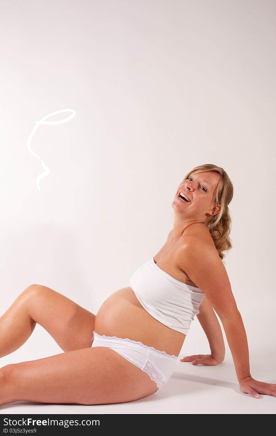 A happy pregnant woman posing. A happy pregnant woman posing