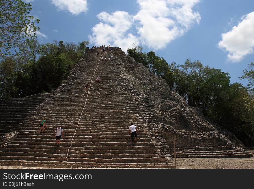 Tourists climb the top of the Coba Main pyramid, highest Maya structure standing 40 Meters above the Yucatan jungles. Tourists climb the top of the Coba Main pyramid, highest Maya structure standing 40 Meters above the Yucatan jungles.