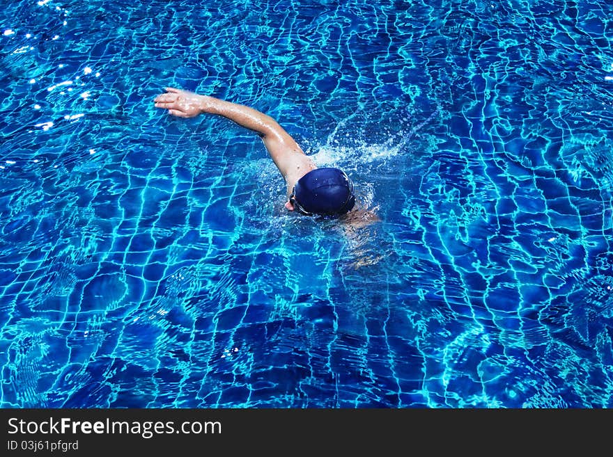 Portrait of young man swimming in pool