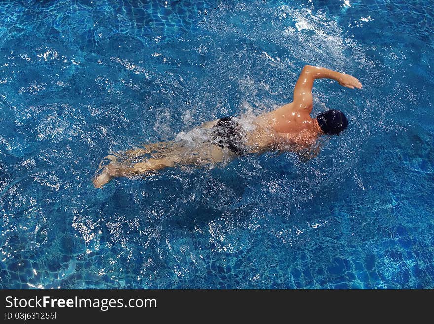 Portrait of young man swimming in pool. Portrait of young man swimming in pool