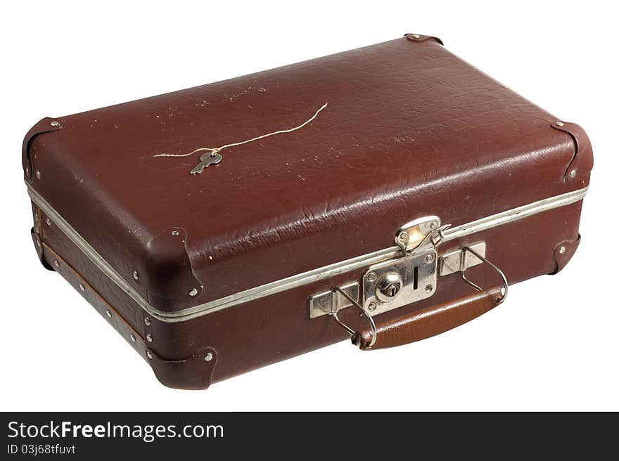 Old scratched suitcase isolated with key