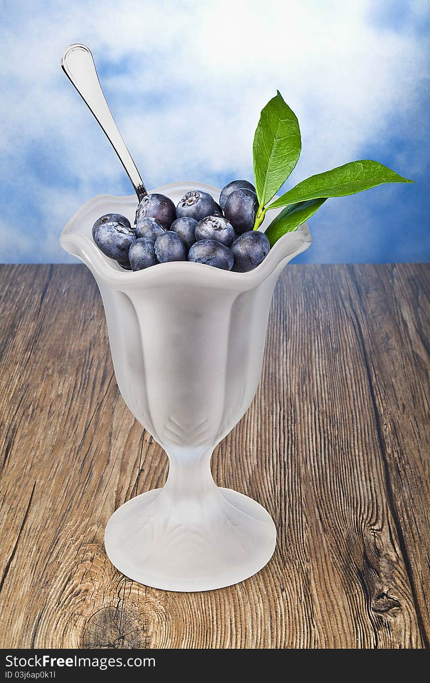 A delicius blueberry cup on wood. A delicius blueberry cup on wood