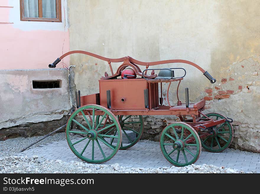 Old fire car near wall.