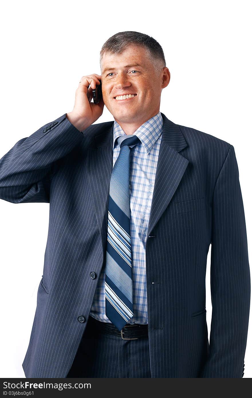 Smiling mature businessman speaking on the phone on the white background. Smiling mature businessman speaking on the phone on the white background.