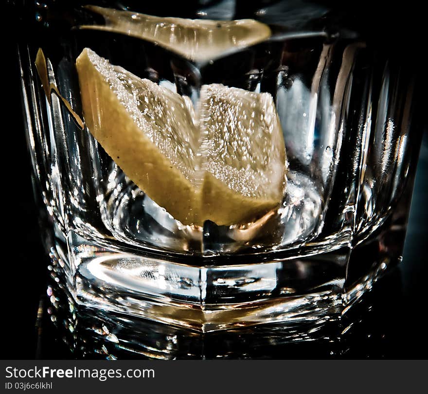 Empty glass closeup with lemon slice inside. Empty glass closeup with lemon slice inside