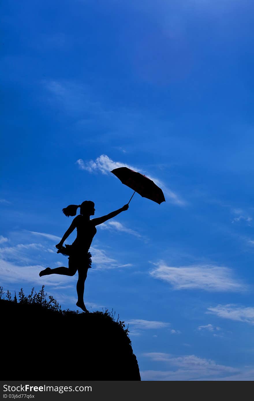 Silhouette of girl flight up with umbrella