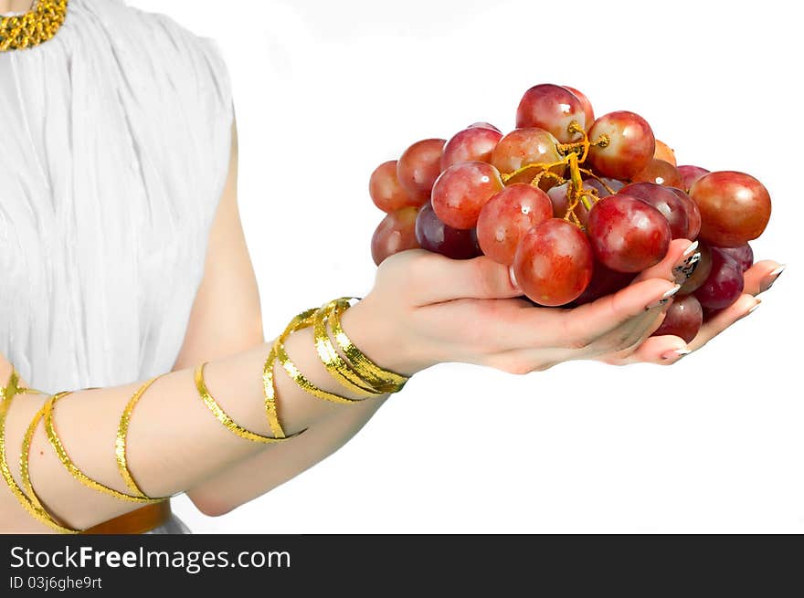 Bunch of grapes in the hands of a young woman