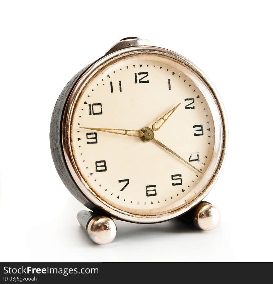 Old desktop alarm clock isolated on white background