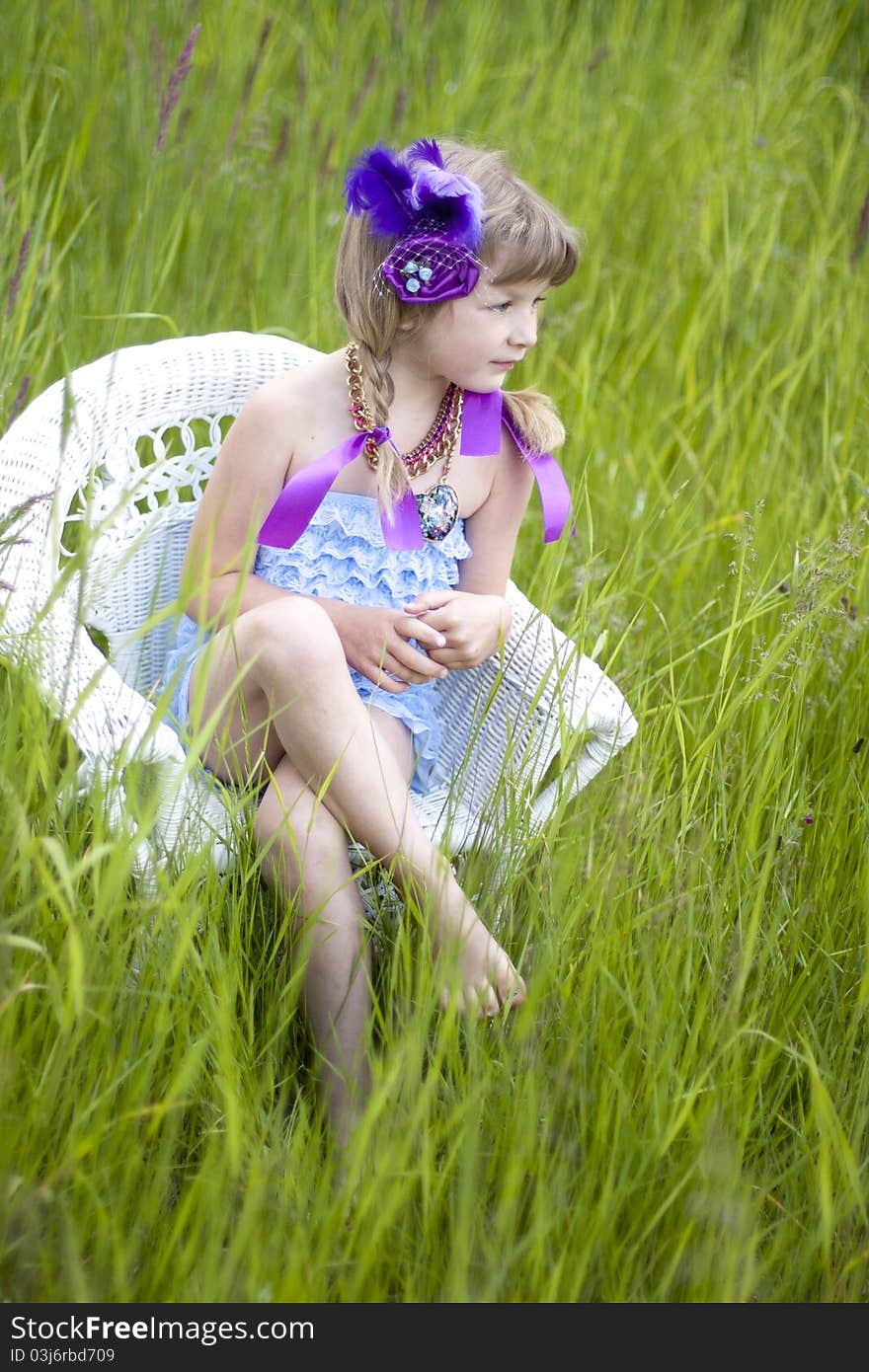 Little girl were a lace petti romper and a feather headband. Little girl were a lace petti romper and a feather headband