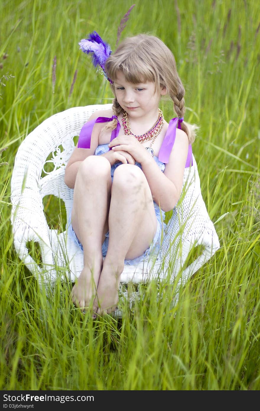 Little girl were a lace petti romper and a feather headband. Little girl were a lace petti romper and a feather headband