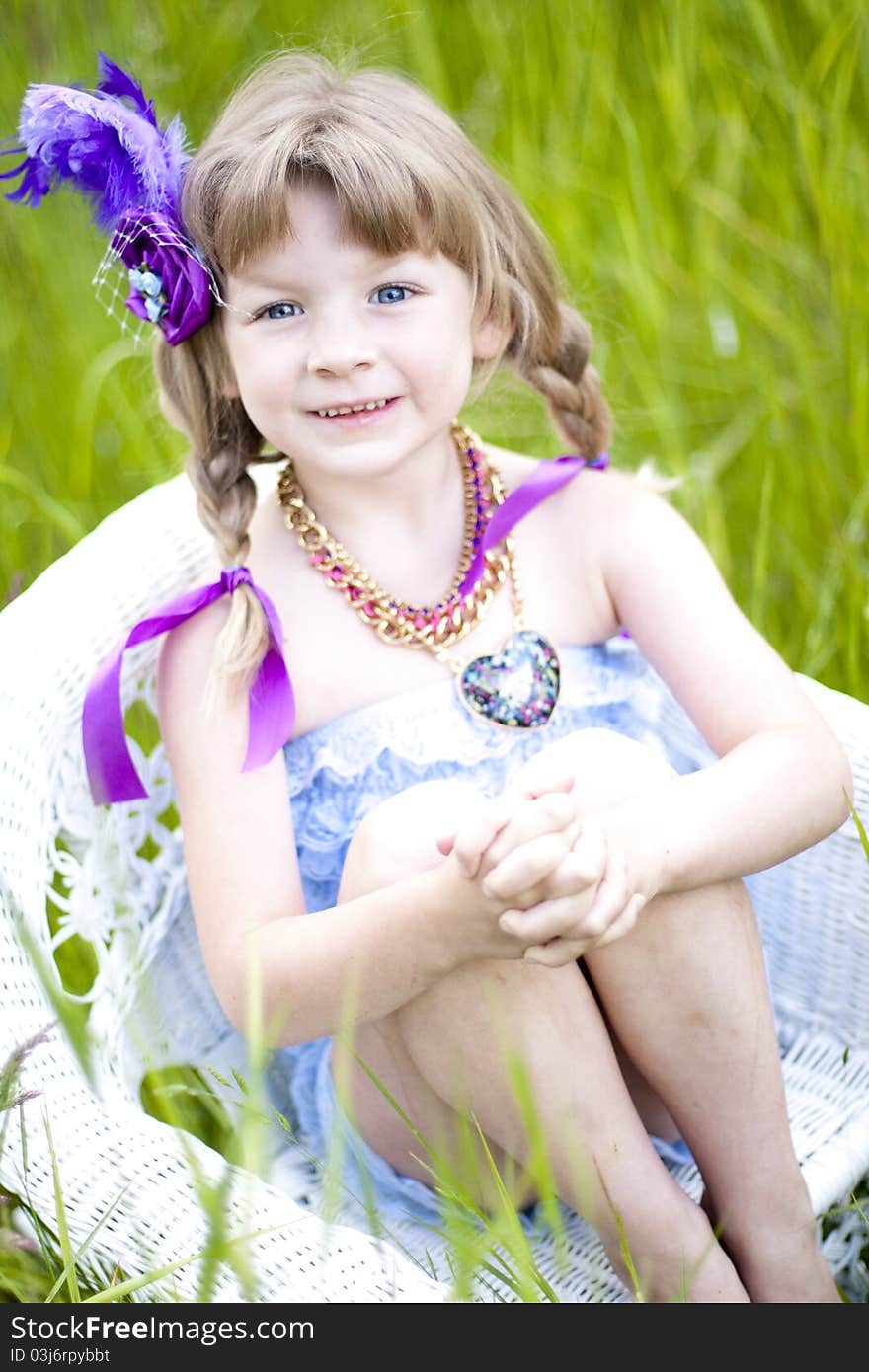 Little girl were a lace petti romper and a feather headband. Little girl were a lace petti romper and a feather headband