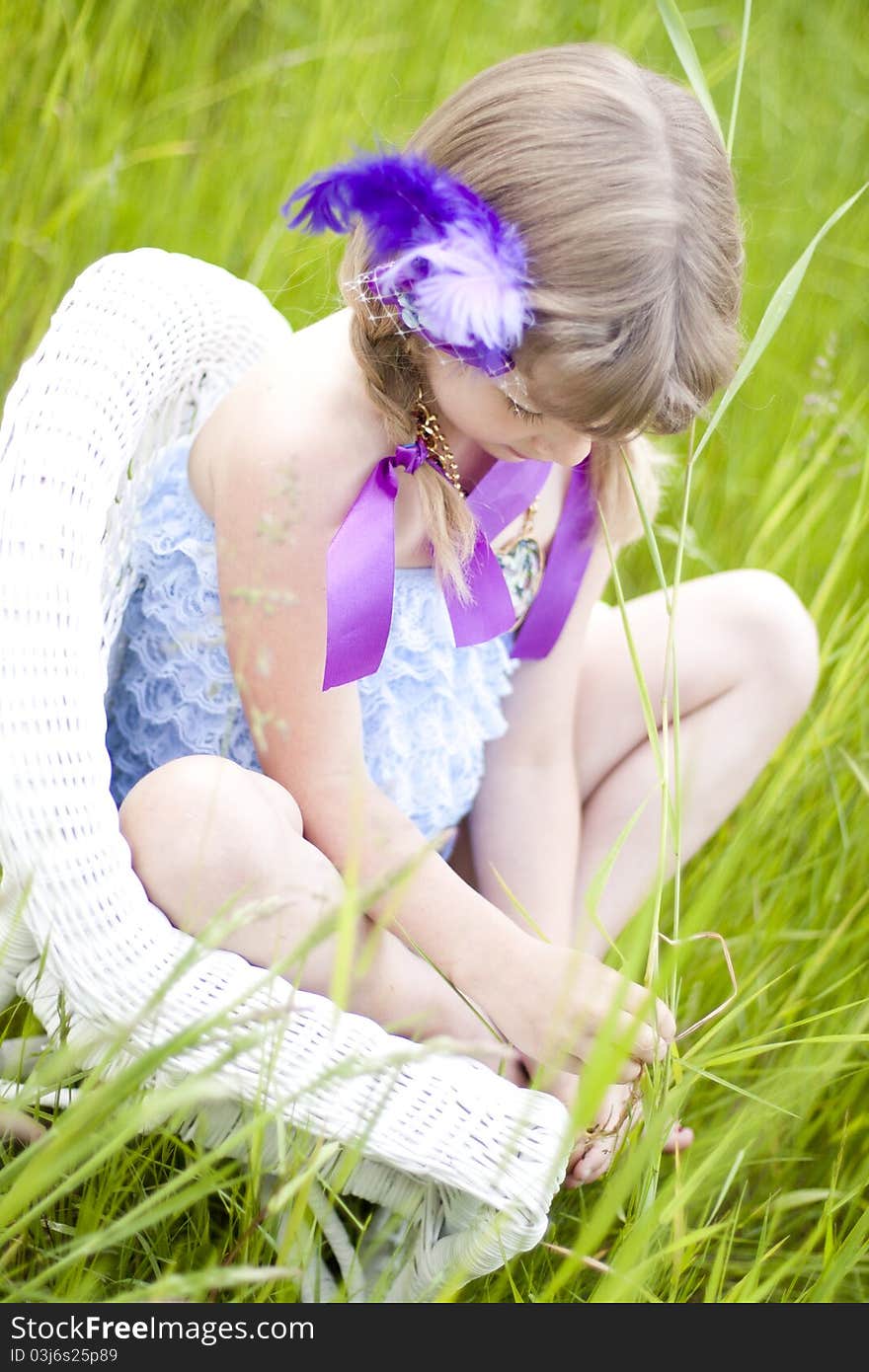 Little girl were a lace petti romper and a feather headband. Little girl were a lace petti romper and a feather headband