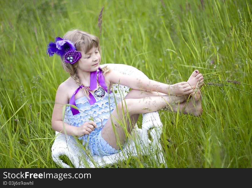 Little girl were a lace petti romper and a feather headband. Little girl were a lace petti romper and a feather headband