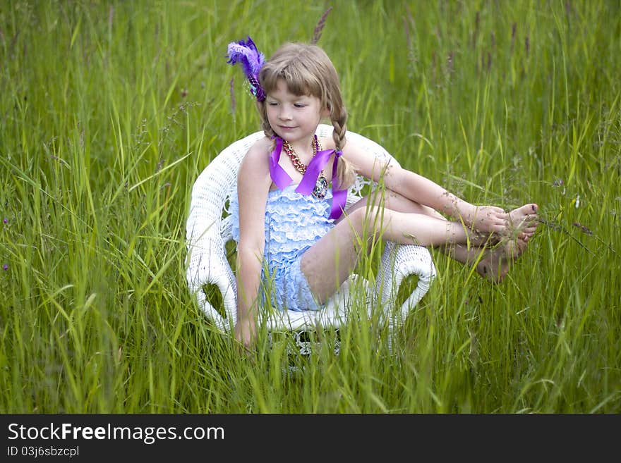 Little girl were a lace petti romper and a feather headband. Little girl were a lace petti romper and a feather headband