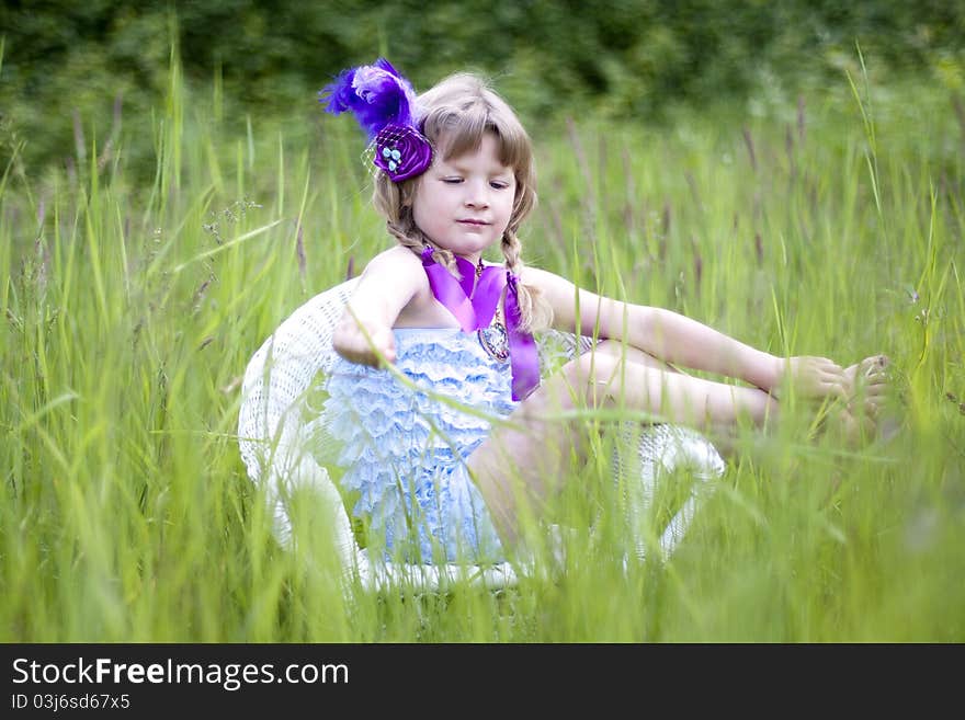 Little girl were a lace petti romper and a feather headband. Little girl were a lace petti romper and a feather headband