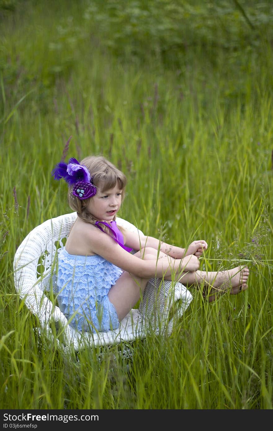 Little girl were a lace petti romper and a feather headband. Little girl were a lace petti romper and a feather headband