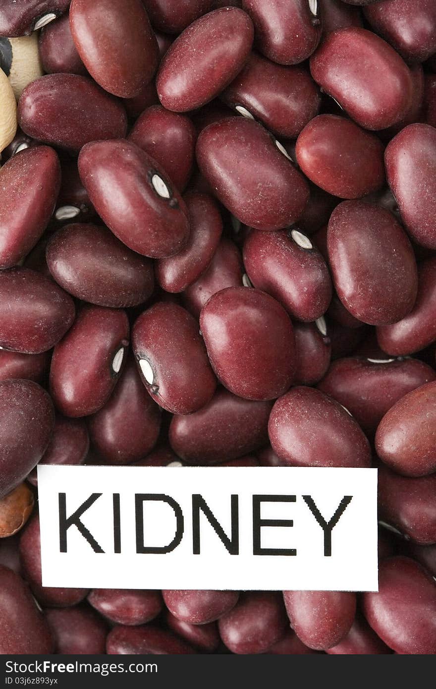 Dried red kidney beans with label close-up macro backround.