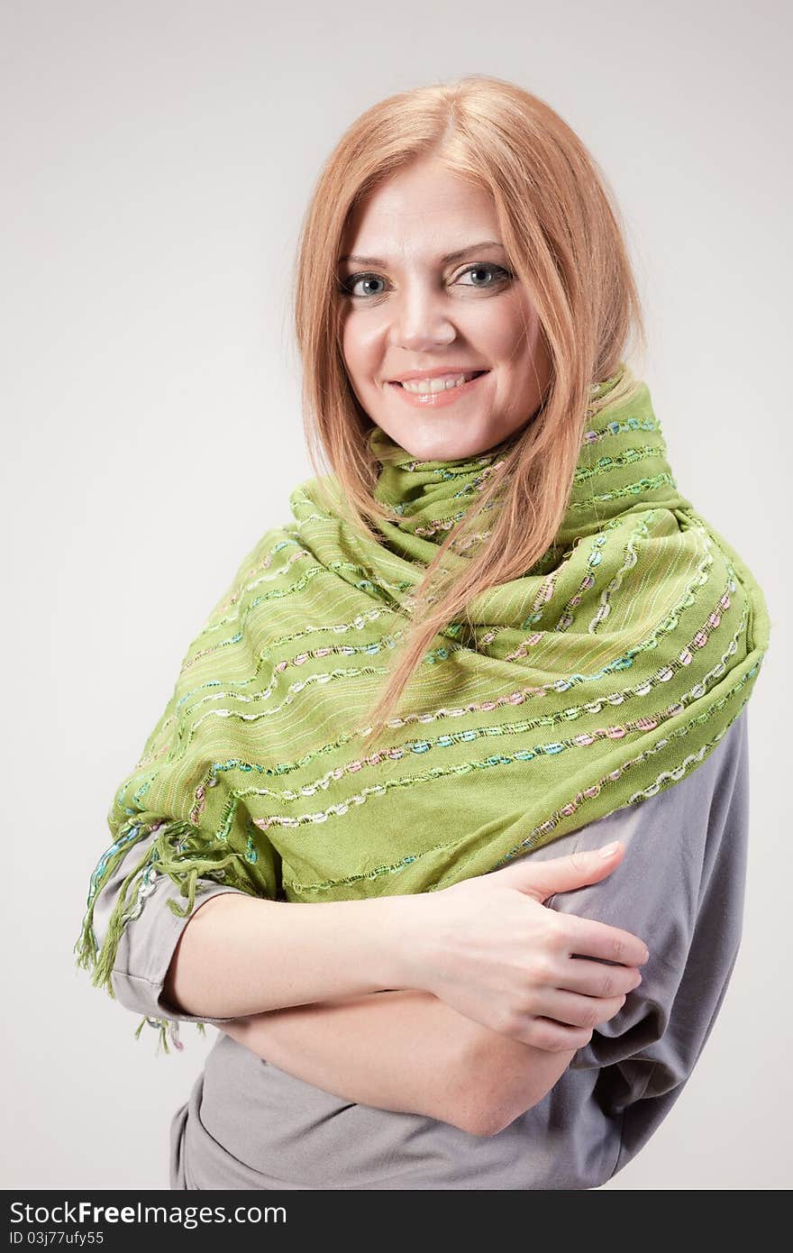 Positive young woman posing for camera in studio