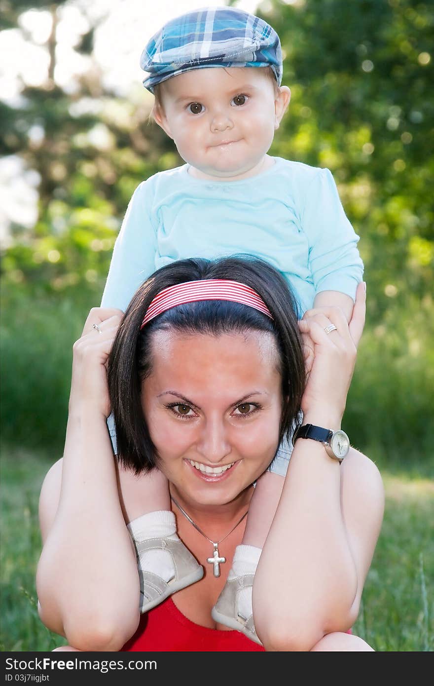 Cute little baby boy with mother outdoors