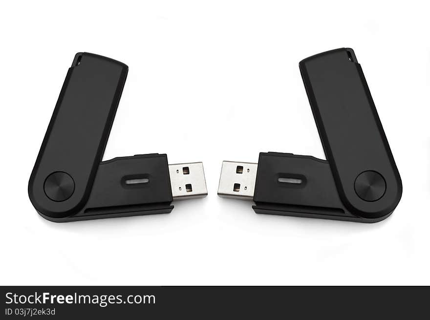 Close up of two black usb sd card adaptors arranged over white. Close up of two black usb sd card adaptors arranged over white