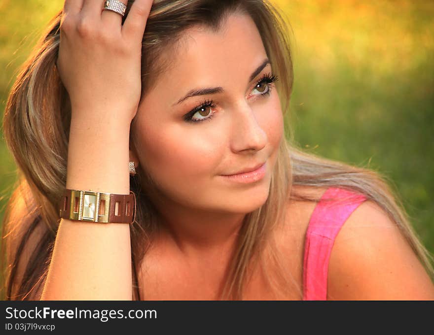 Beautiful young woman relaxing on a grass. Beautiful young woman relaxing on a grass