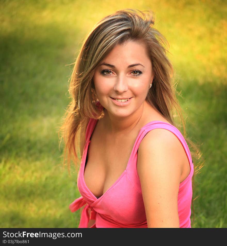 Beautiful young woman relaxing on a grass. Beautiful young woman relaxing on a grass