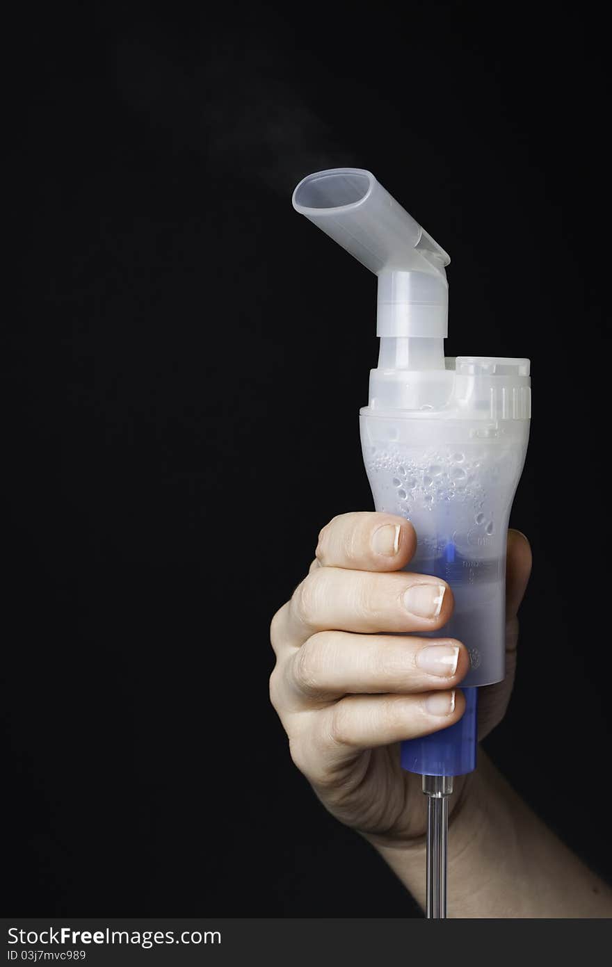 Hand holds the mouthpiece of the inhaler evaporating medicine (medical background). Hand holds the mouthpiece of the inhaler evaporating medicine (medical background)