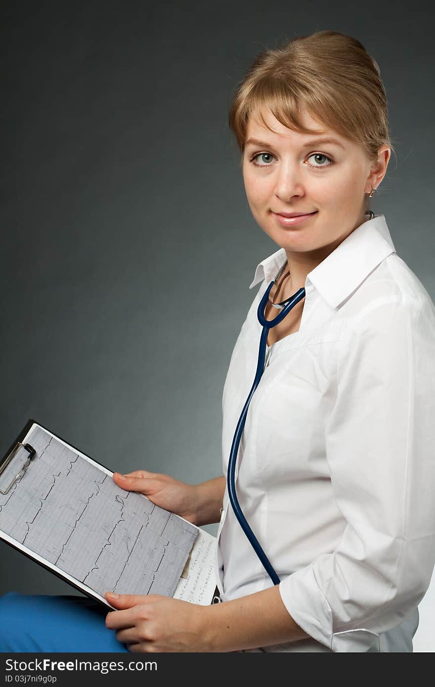 Doctor with stethoscope and electrocardiogram