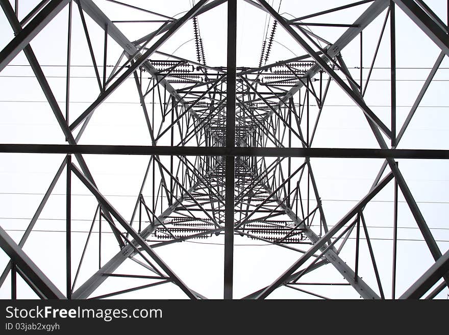 View of a high voltage electric pylon from the bottom of inside