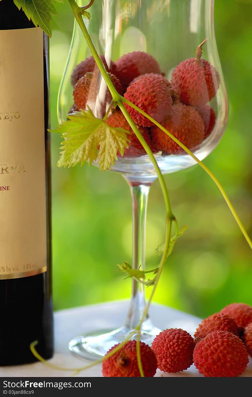 Bottle of Red wine and red fruits in glass. Bottle of Red wine and red fruits in glass.