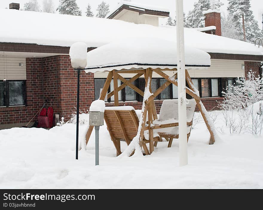 Winter cottage and pergola covered by snow in Finland. Winter cottage and pergola covered by snow in Finland