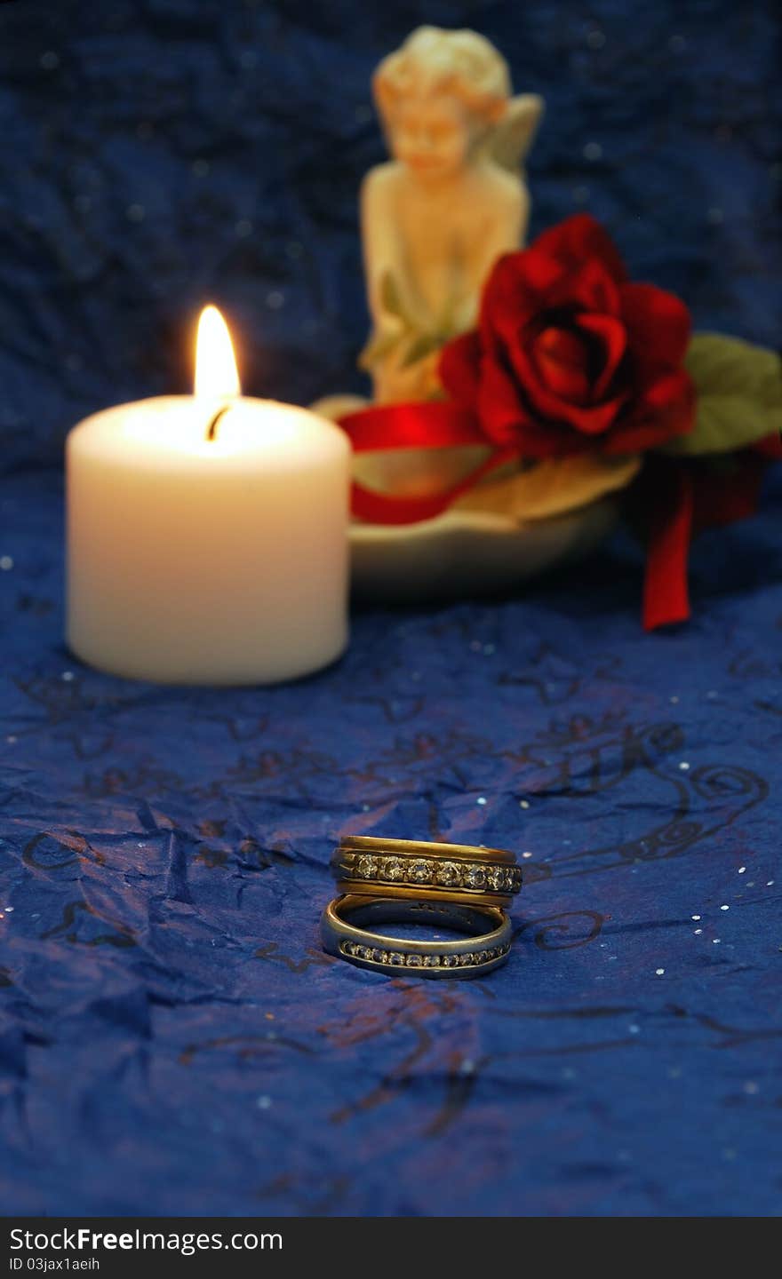 Wedding bands on deep blue background with red accents. Wedding bands on deep blue background with red accents