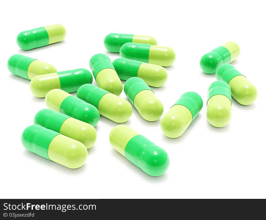 Many green pills on white