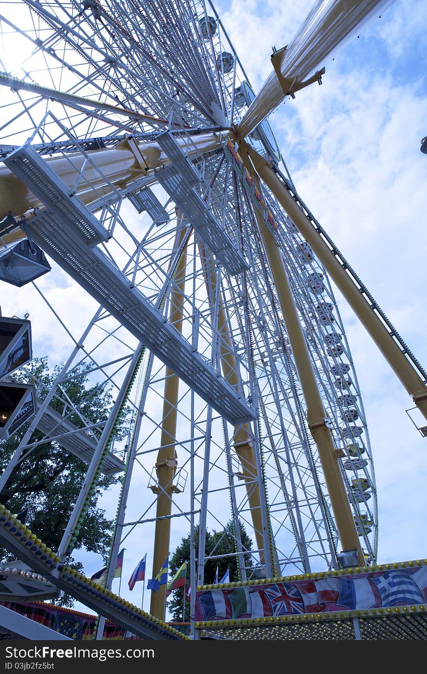 This ferris wheel is over 40 m high. It is one of the attractions at the funfair. This ferris wheel is over 40 m high. It is one of the attractions at the funfair.