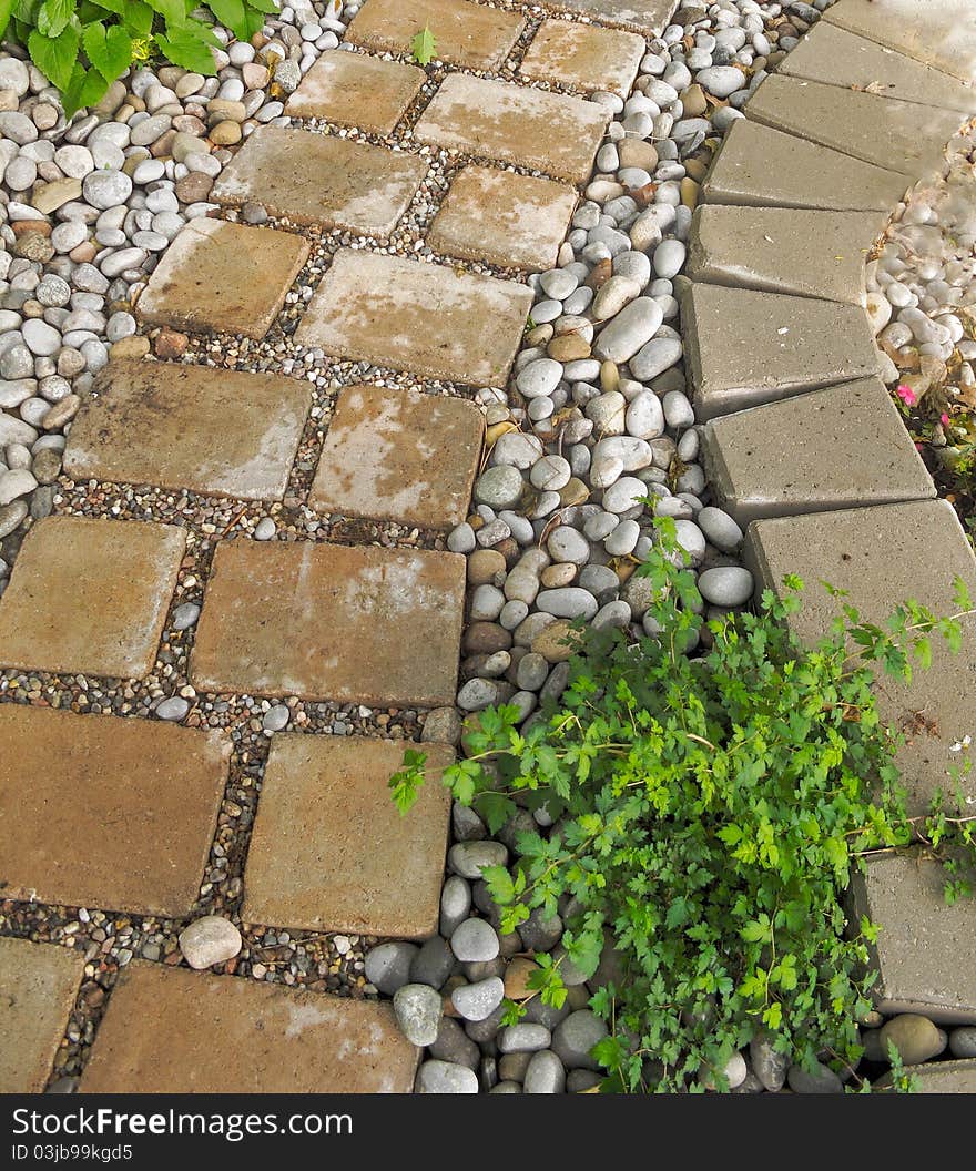 Brick and pebble pathway leading through garden. Brick and pebble pathway leading through garden