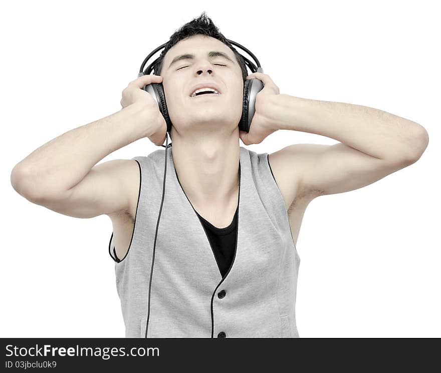 Teenager listening music on headphones isolated on white background:NOTE:Grain was added.Strong contrast photography. Teenager listening music on headphones isolated on white background:NOTE:Grain was added.Strong contrast photography