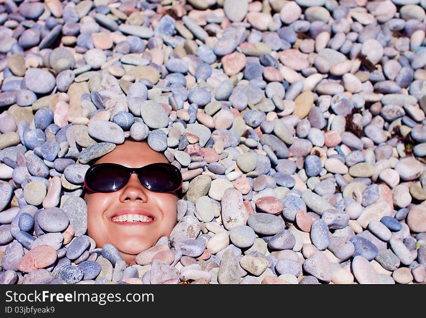 Funny girl in sunglasses in stones. Funny girl in sunglasses in stones